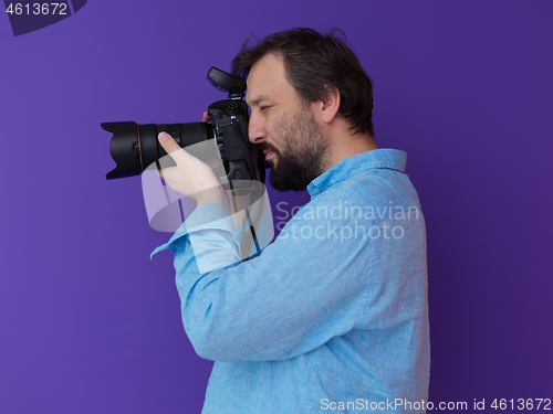 Image of Portrait of  male Photographer purple background