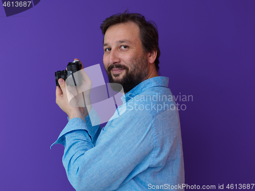 Image of Portrait of  male Photographer purple background