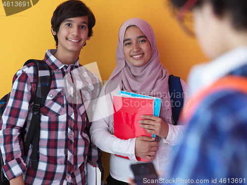 Image of Arab teenagers group working on laptop  computer together