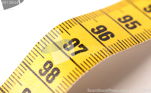 Image of Close-up of a yellow measuring tape isolated on white - 97