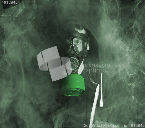 Image of Man in a gas mask in the smoke