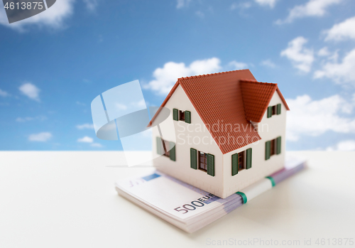 Image of close up of home or house model and money