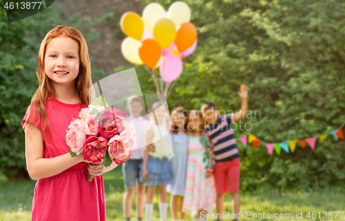 Image of red haired girl with flowers at birthday party
