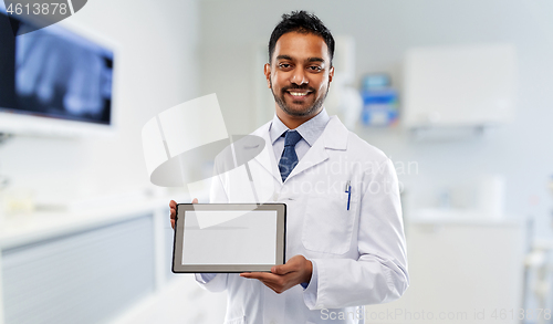 Image of male dentist with tablet computer at dental clinic