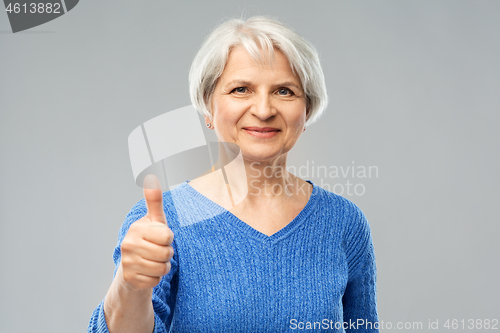 Image of smiling senior woman r showing thumbs up