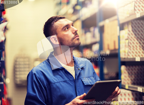 Image of auto mechanic or smith with tablet pc at workshop