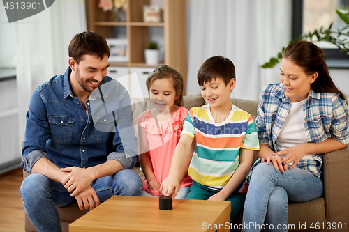 Image of happy family with smart speaker at home