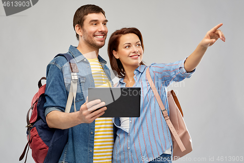 Image of happy couple of tourists with tablet computer