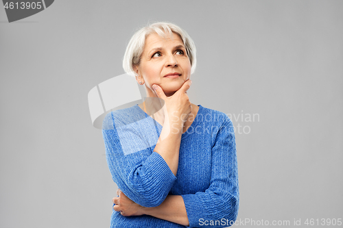 Image of portrait of senior woman in blue sweater thinking