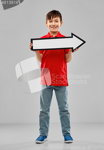 Image of boy holding big white rightwards thick arrow