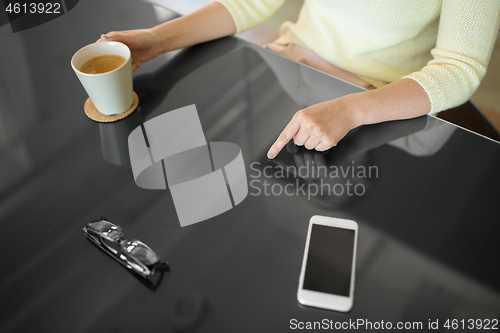 Image of woman with coffee using black interactive panel