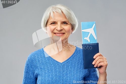 Image of senior woman with passport and airplane ticket