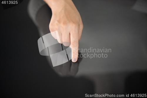 Image of hand using black interactive panel