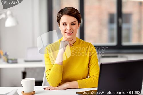 Image of businesswoman with laptop computer at office