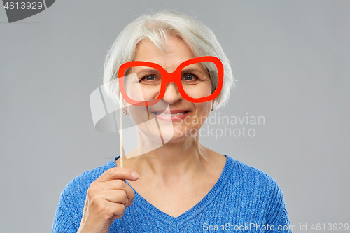 Image of funny senior woman with big party glasses