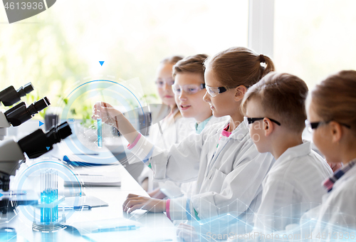 Image of kids with test tubes studying chemistry at school