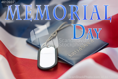 Image of dog tag or badge and passport on american flag