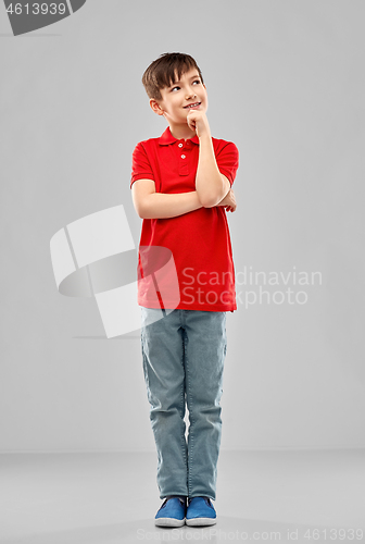 Image of thinking boy in red polo t-shirt