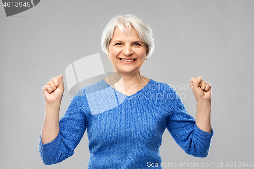 Image of portrait of happy senior woman celebrating success