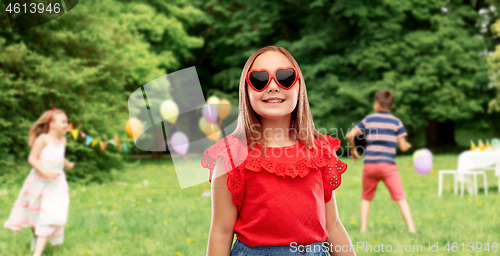 Image of girl in heart shaped sunglasses at birthday party