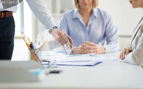 Image of business team discussing papers at office