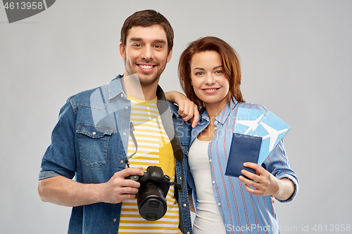 Image of happy couple with air tickets, passport and camera