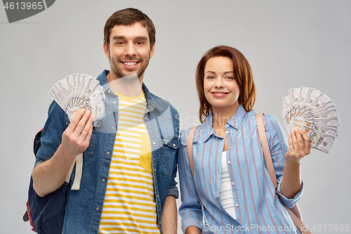 Image of couple of tourists with backpacks and money