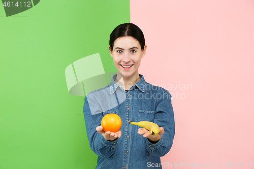 Image of Beautiful close-up portrait of young woman with fruits. Healthy food concept.