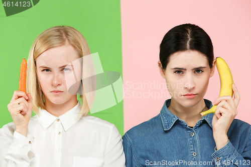 Image of Beautiful close-up portrait of young women with fruits and vegetables. Healthy food concept.