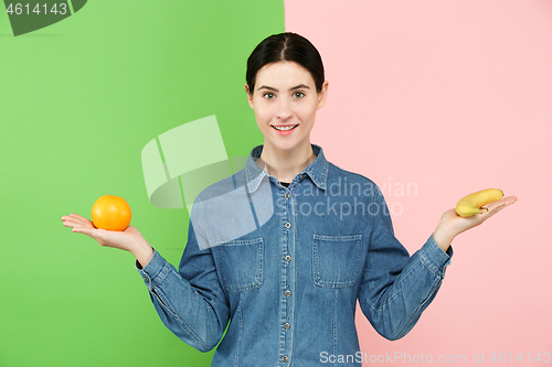 Image of Beautiful close-up portrait of young woman with fruits. Healthy food concept.