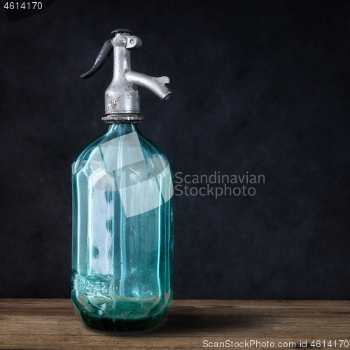 Image of vintage turquoise soda glass bottle