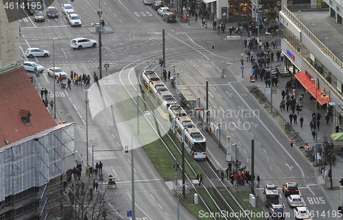 Image of BERLIN, GERMANY on December 31, 2019: People pass tram ways in t