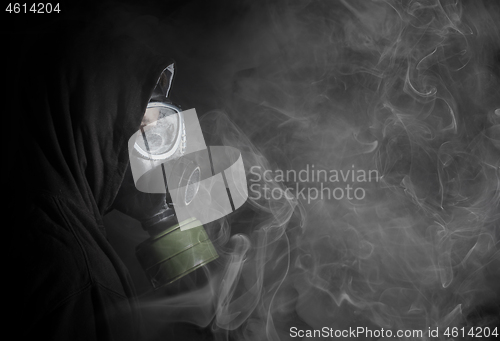 Image of Man in a gas mask in the smoke