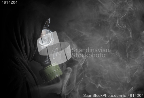 Image of Man in a gas mask in the smoke