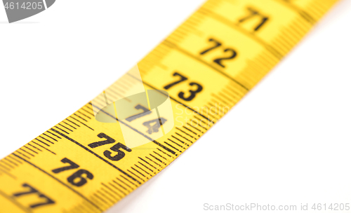 Image of Close-up of a yellow measuring tape isolated on white - 75