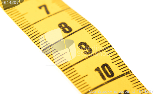 Image of Close-up of a yellow measuring tape isolated on white - 9