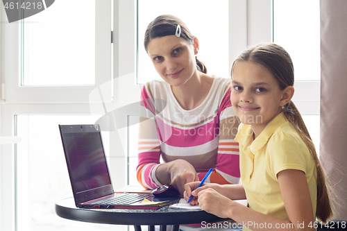 Image of Tutor and student distracted from class and looked into the frame