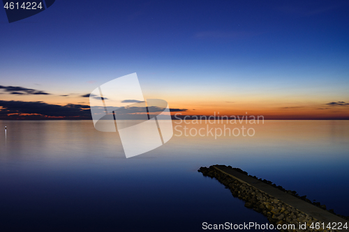 Image of Seascape after sunset, breakwater goes from the coast