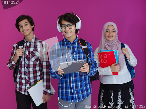 Image of Arab teenagers group working on laptop  computer together