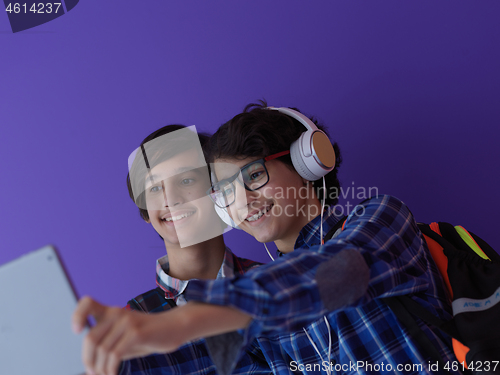Image of Arab teenagers group working on laptop  computer together