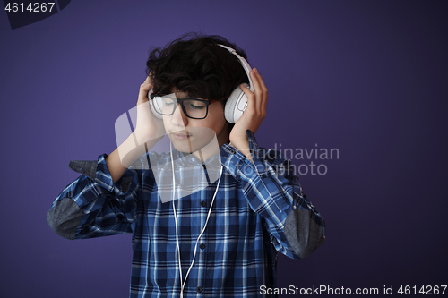 Image of Teenage Boy Wearing Headphones And Listening To Music