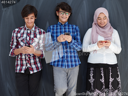 Image of arab teenagers group using smart phones for social media network