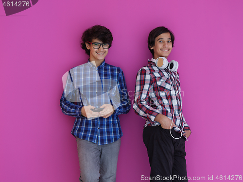Image of Arab teenagers  against pink wall