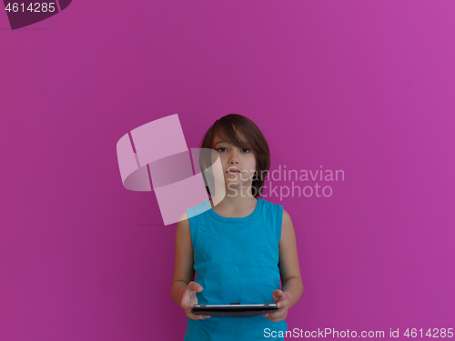 Image of Little Arabian boy using  on digital tablet pink background