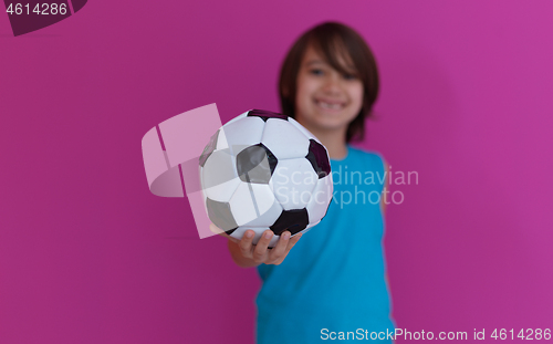 Image of Arabic boy with soccer ball against  pink background