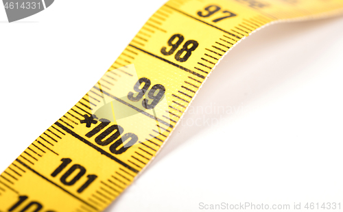 Image of Close-up of a yellow measuring tape isolated on white - 100