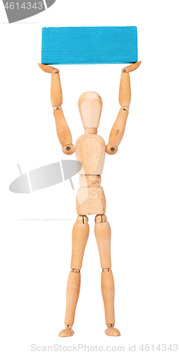 Image of Wooden mannequin carrying a wooden block