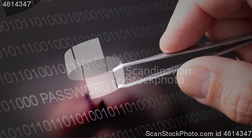 Image of Binary code, password vulnerability taking out with tweezers