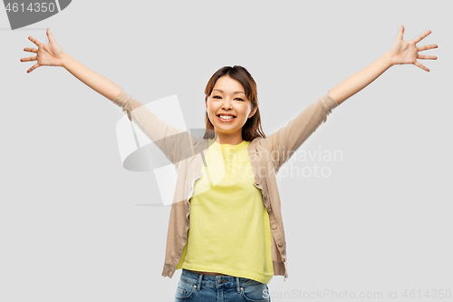 Image of happy asian woman celebrating success