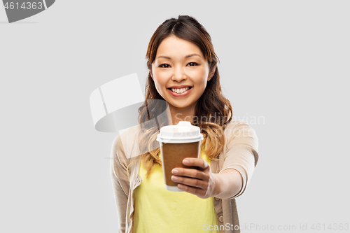 Image of happy asian woman drinking coffee